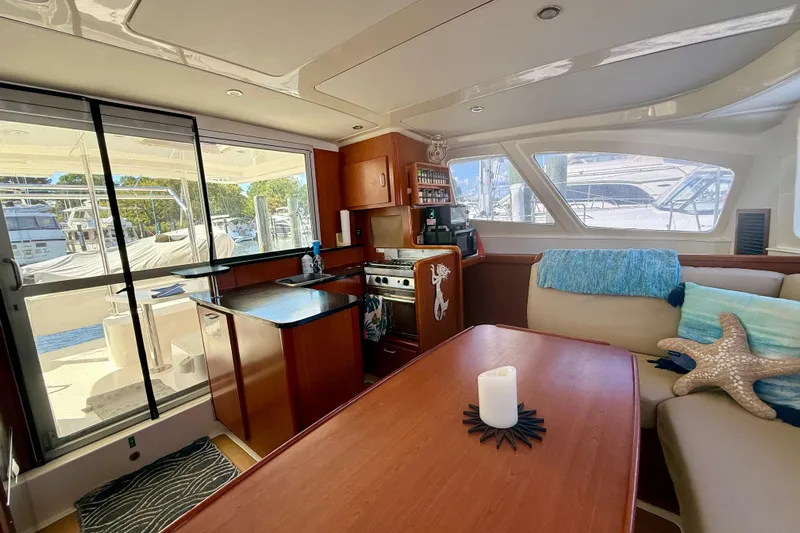  Yacht Photos Pics Interior of 2012 Leopard 39 yacht with kitchen, dining area, and large windows.