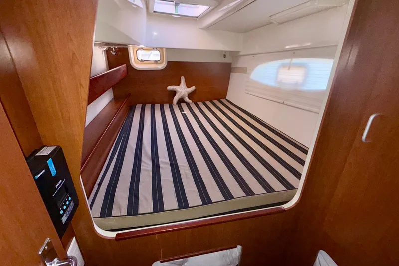 Yacht Photos Pics Cozy cabin interior of 2012 Leopard 39 yacht with striped bedding and starfish decor.