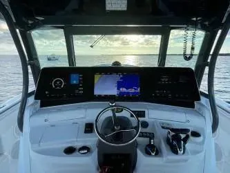  Yacht Photos Pics 2019 HCB 53 Sue&ntilde;os boat dashboard with navigation screens, steering wheel, and controls at sea.