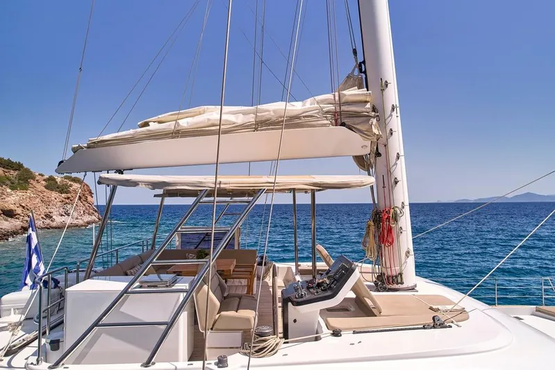 Adara Yacht Photos Pics 2020 Sunreef 50 yacht deck with seating, ocean view, and clear blue sky.