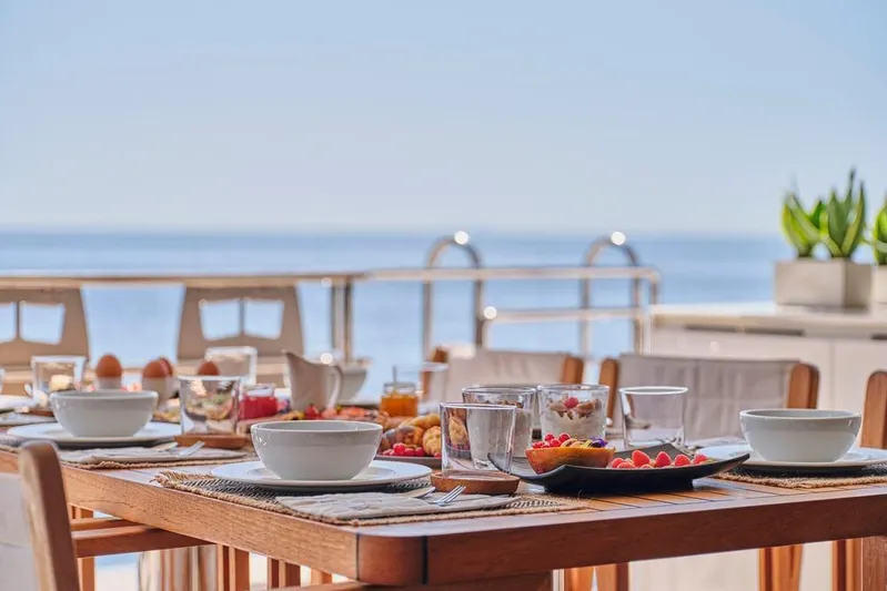 Adara Yacht Photos Pics Luxurious breakfast setup on Sunreef 50 yacht, 2020 model, with ocean view.