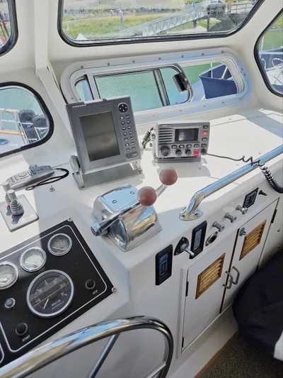 Blue Agave Yacht Photos Pics 1983 Ocean Alexander 43 Flush Aft Deck yacht helm with navigation equipment and controls.