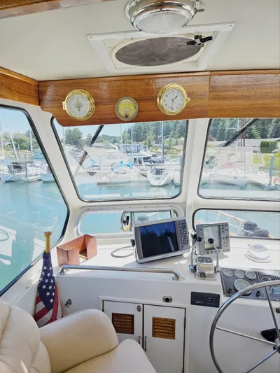 Blue Agave Yacht Photos Pics 1983 Ocean Alexander 43 Flush Aft Deck helm with navigation equipment and marina view.