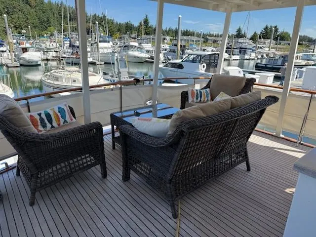 Blue Agave Yacht Photos Pics 1983 Ocean Alexander 43 Flush Aft Deck yacht with wicker seating, marina view.