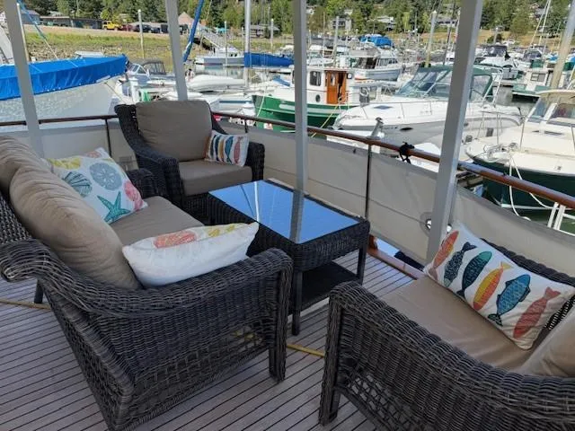 Blue Agave Yacht Photos Pics Outdoor seating on 1983 Ocean Alexander 43 Flush Aft Deck yacht, marina view.