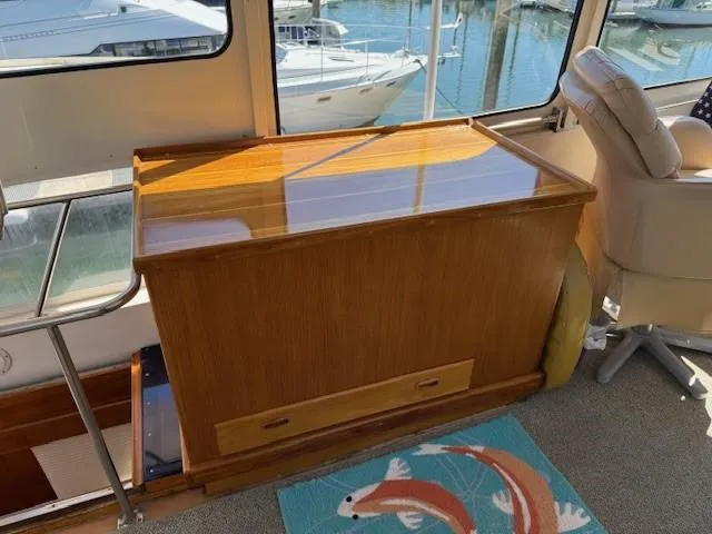 Blue Agave Yacht Photos Pics 1983 Ocean Alexander 43 Flush Aft Deck interior with wooden cabinet with freezer inside