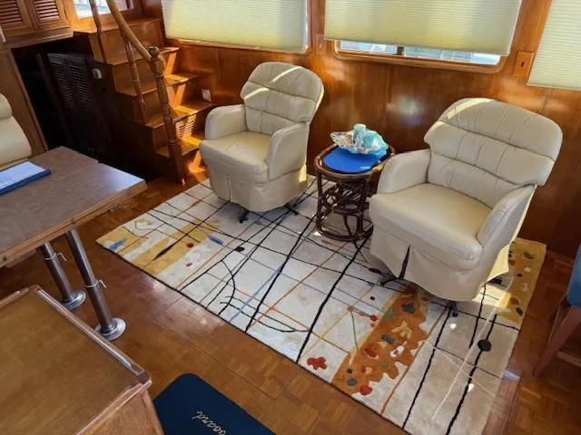 Blue Agave Yacht Photos Pics Interior of 1983 Ocean Alexander 43 yacht with plush chairs and decorative rug.