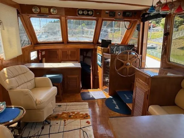 Blue Agave Yacht Photos Pics 1983 Ocean Alexander 43 Flush Aft Deck yacht interior with wood paneling and steering wheel.