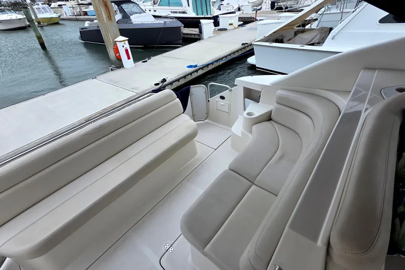  Yacht Photos Pics 2002 Regal Commodore 4260 boat interior with beige seating at a marina.