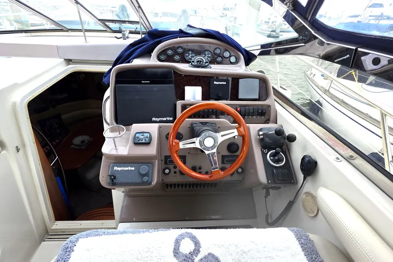  Yacht Photos Pics 2002 Regal Commodore 4260 yacht cockpit with steering wheel and navigation equipment.