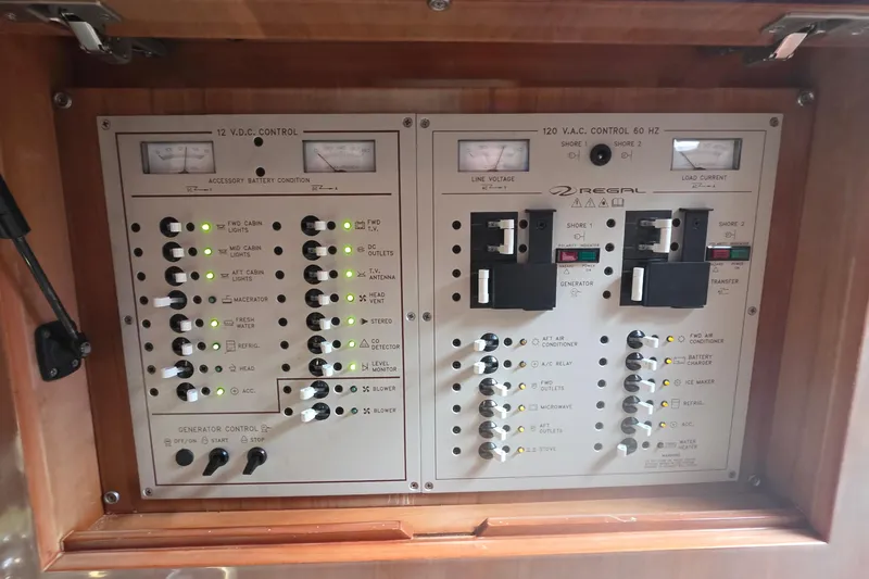  Yacht Photos Pics Electrical control panel of a 2002 Regal Commodore 4260 boat, featuring various switches and indicators.