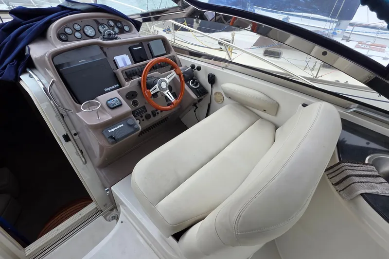  Yacht Photos Pics Cockpit of 2002 Regal Commodore 4260 yacht with steering wheel and navigation controls.