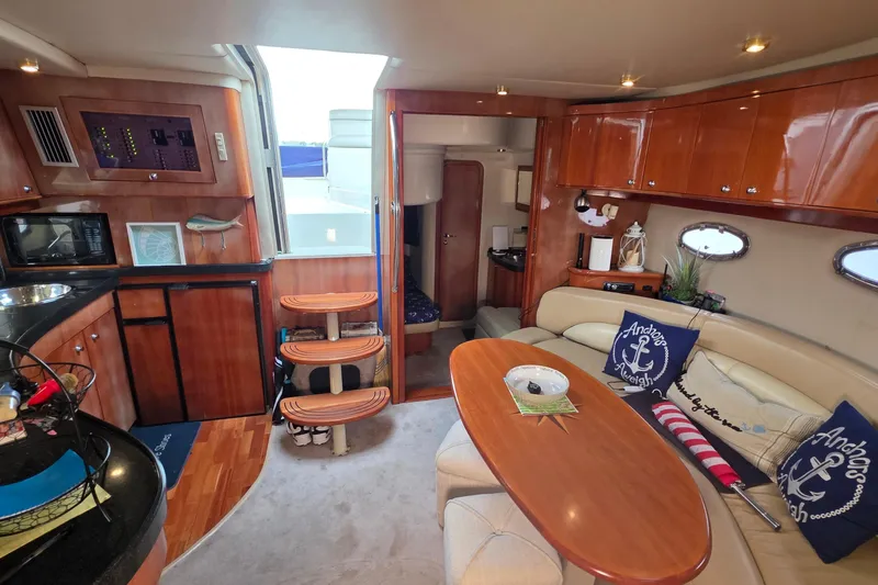  Yacht Photos Pics Luxurious interior of 2002 Regal Commodore 4260 yacht with elegant wood finishes and cozy seating.