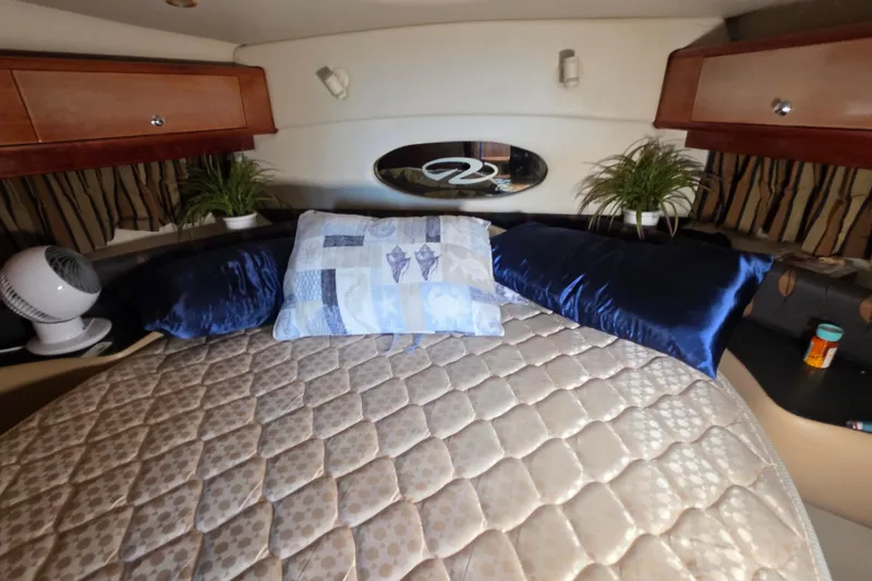  Yacht Photos Pics Luxurious cabin interior of 2002 Regal Commodore 4260 yacht with plush bedding and decor.