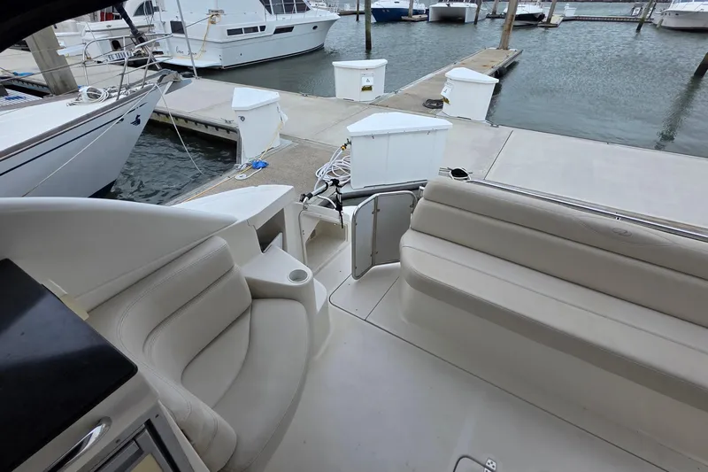  Yacht Photos Pics 2002 Regal Commodore 4260 yacht interior with seating, docked at marina.