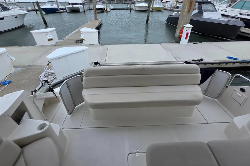  Yacht Photos Pics 2002 Regal Commodore 4260 yacht with beige seating at a marina dock.