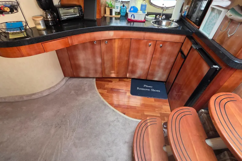  Yacht Photos Pics Interior of 2002 Regal Commodore 4260 yacht with kitchenette and "Please Remove Shoes" mat.