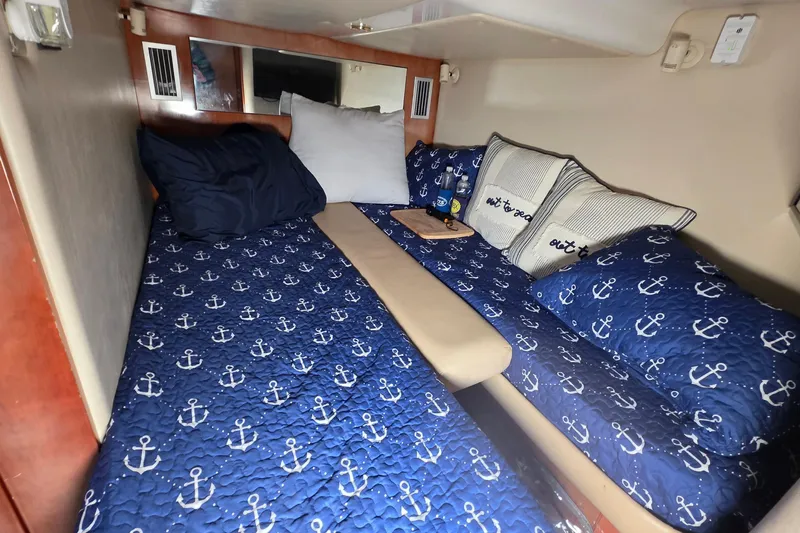  Yacht Photos Pics Cozy cabin interior of 2002 Regal Commodore 4260 with nautical-themed bedding.
