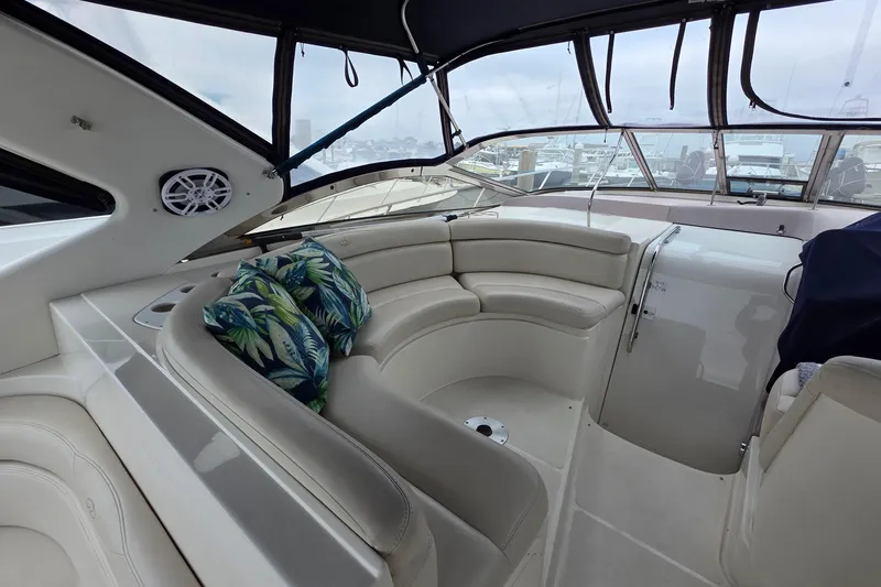  Yacht Photos Pics Luxurious 2002 Regal Commodore 4260 yacht interior with plush seating and tropical cushions.