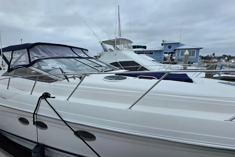  Yacht Photos Pics 2002 Regal Commodore 4260 yacht docked at marina under cloudy skies.