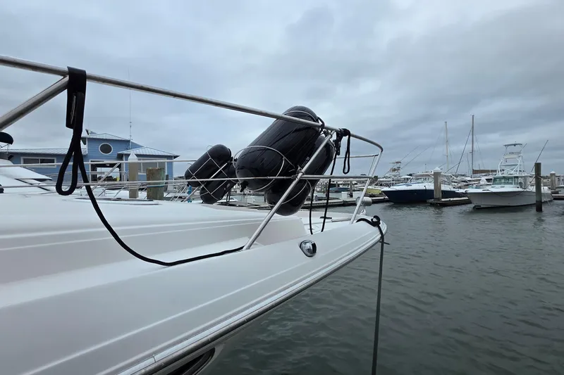  Yacht Photos Pics 2002 Regal Commodore 4260 yacht docked at marina with cloudy sky.