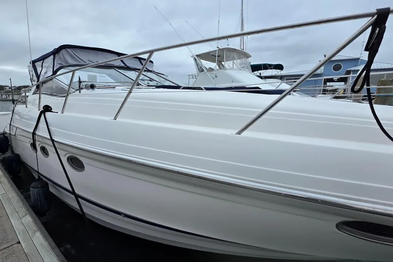  Yacht Photos Pics 2002 Regal Commodore 4260 yacht docked at marina under cloudy sky.