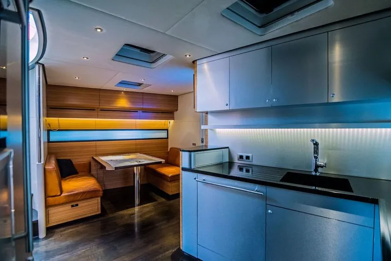  Yacht Photos Pics Luxurious interior of 2011 Acico 74 yacht with modern kitchen and cozy dining area.