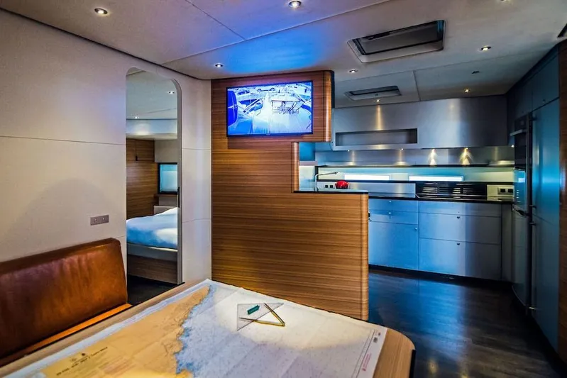  Yacht Photos Pics Luxurious interior of 2011 Acico 74 yacht featuring modern kitchen and navigation table.