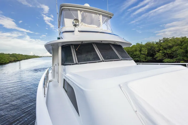  Yacht Photos Pics 1987 Hatteras 70 Cockpit Motor Yacht cruising on a serene waterway.