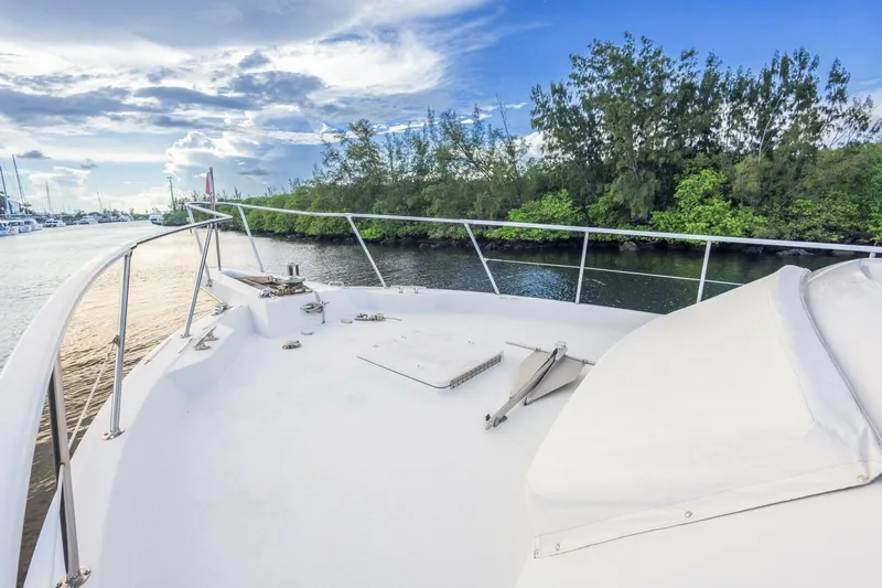  Yacht Photos Pics 1987 Hatteras 70 Cockpit Motor Yacht deck with scenic waterway and lush greenery.