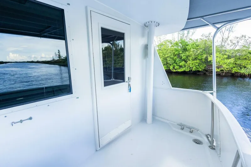  Yacht Photos Pics 1987 Hatteras 70 Cockpit Motor Yacht deck with scenic waterway view.