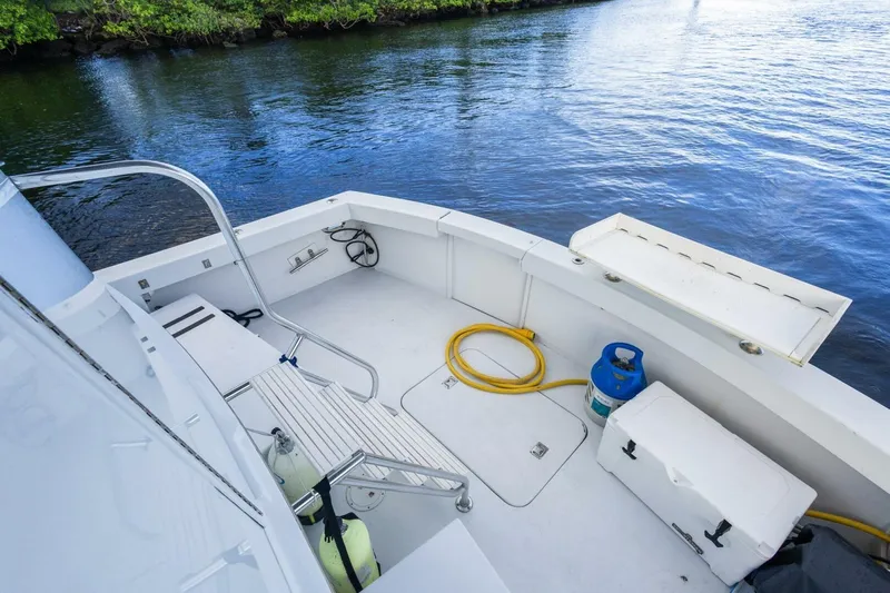  Yacht Photos Pics 1987 Hatteras 70 Cockpit Motor Yacht deck with water view, featuring equipment and storage.