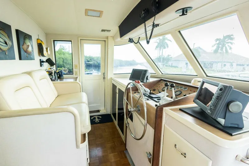  Yacht Photos Pics Interior of 1987 Hatteras 70 Cockpit Motor Yacht helm with steering wheel and navigation equipment.