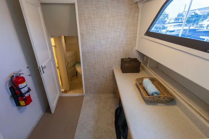  Yacht Photos Pics Interior of 1987 Hatteras 70 Cockpit Motor Yacht with window, counter, and fire extinguisher.