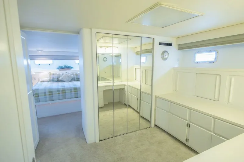  Yacht Photos Pics Luxurious interior of 1987 Hatteras 70 Cockpit Motor Yacht with mirrored closet and cozy bedroom.