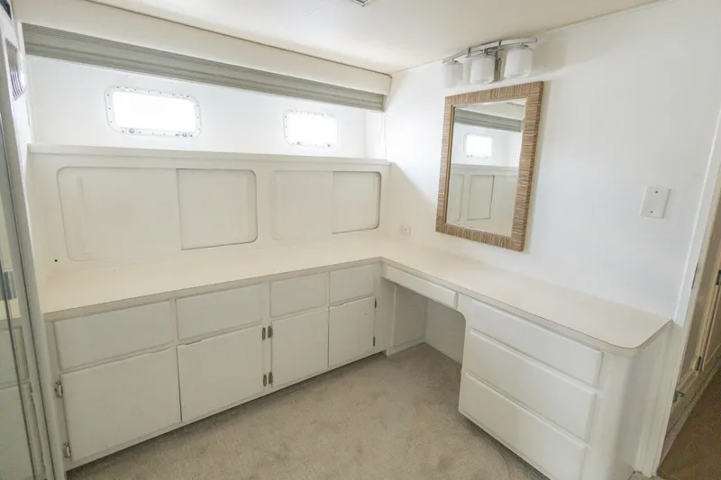  Yacht Photos Pics Interior of 1987 Hatteras 70 Cockpit Motor Yacht with white cabinetry and mirror.