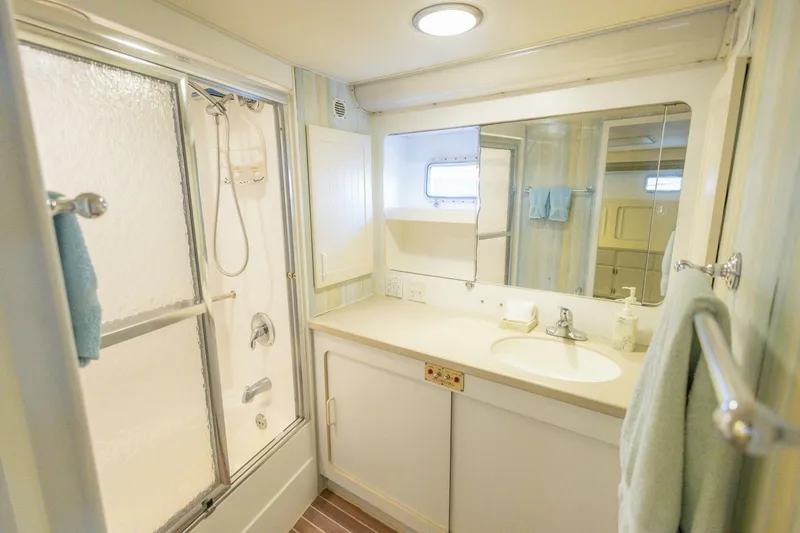 Yacht Photos Pics Bathroom interior of 1987 Hatteras 70 Cockpit Motor Yacht with shower and vanity.