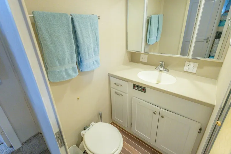  Yacht Photos Pics Bathroom interior of 1987 Hatteras 70 Cockpit Motor Yacht with sink and towels.