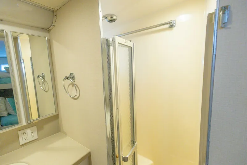  Yacht Photos Pics Bathroom interior of 1987 Hatteras 70 Cockpit Motor Yacht with shower and mirror.