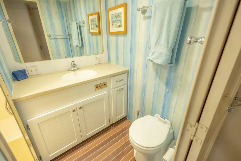  Yacht Photos Pics Bathroom interior of 1987 Hatteras 70 Cockpit Motor Yacht with striped wallpaper.
