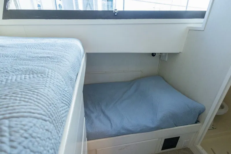  Yacht Photos Pics Interior cabin of 1987 Hatteras 70 Cockpit Motor Yacht with blue bedding.