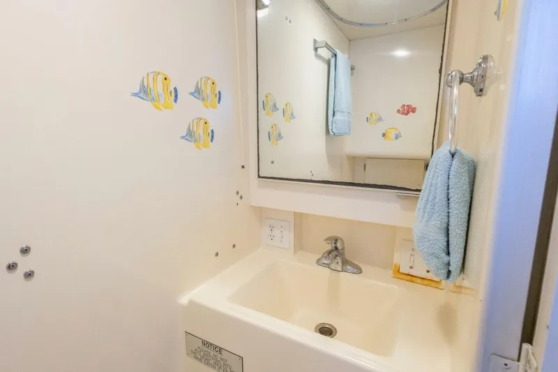  Yacht Photos Pics Bathroom of 1987 Hatteras 70 Cockpit Motor Yacht with fish decals and towel.