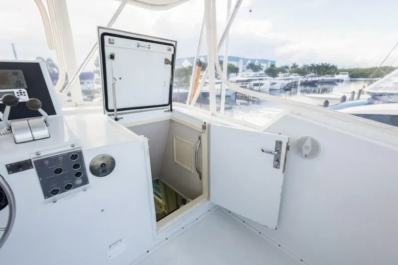  Yacht Photos Pics 1987 Hatteras 70 Cockpit Motor Yacht helm with open hatch and marina view.