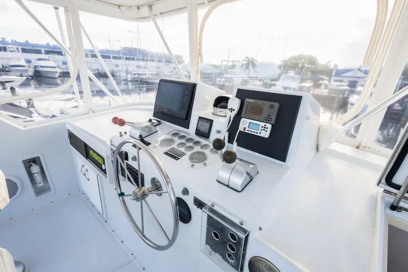  Yacht Photos Pics Cockpit of 1987 Hatteras 70 Cockpit Motor Yacht with steering wheel and navigation controls.