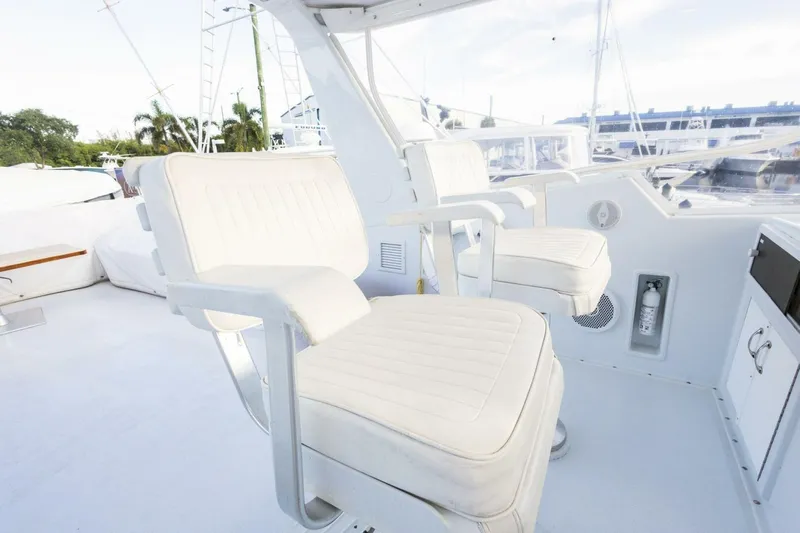  Yacht Photos Pics White seating on 1987 Hatteras 70 Cockpit Motor Yacht deck, featuring modern design.