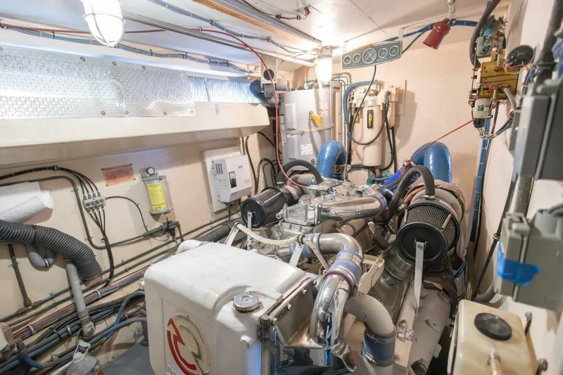  Yacht Photos Pics Engine room of 1987 Hatteras 70 Cockpit Motor Yacht, showcasing mechanical components and wiring.