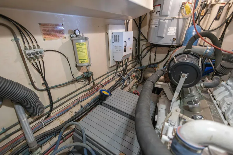  Yacht Photos Pics Engine room of 1987 Hatteras 70 Cockpit Motor Yacht, showcasing wiring and machinery.