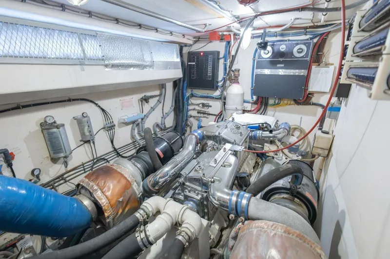  Yacht Photos Pics Engine room of 1987 Hatteras 70 Cockpit Motor Yacht, showcasing mechanical components and wiring.