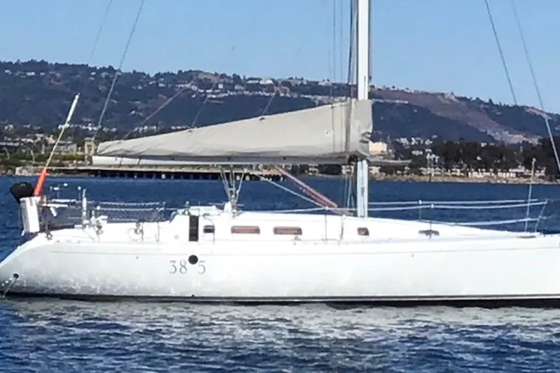 Marianne Yacht Photos Pics 1991 Beneteau First 38s5 sailboat on calm water with scenic mountain backdrop.