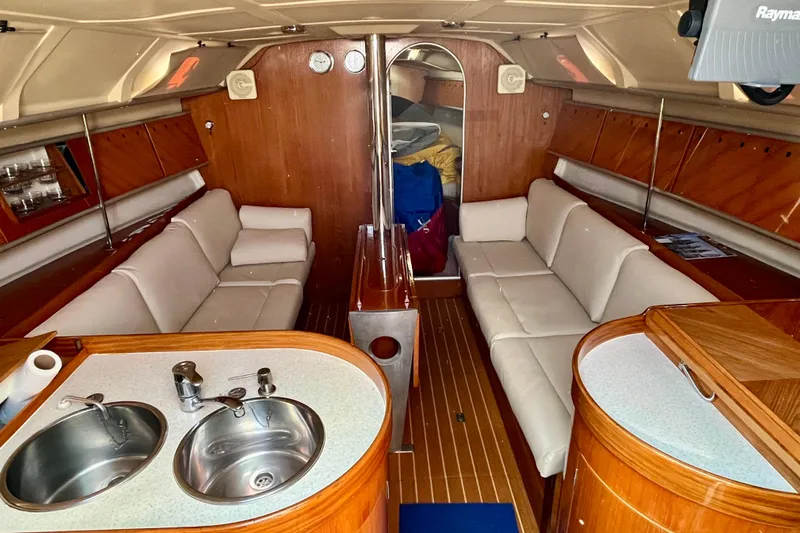 Marianne Yacht Photos Pics Luxurious interior of a 1991 Beneteau First 38s5 sailboat with elegant wood finish.